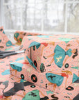 Vintage rock and roll wrapping paper with records and milkshakes and girls in poodle skirts dancing, pink background with pastels side view