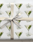 Gift wrapped in paper with martini glass design, two olives inscribed with a 4 and 0.