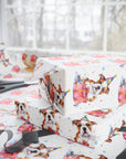 Birthday bulldog wrapping paper featuring a cute puppy wearing a party hat and sitting on a pink gift with hearts and confetti