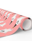 Roll of pink wrapping paper with retro ghost with party hats.