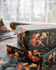 Christmas wrapping paper featuring a flirty 1950s Mrs. Claus dancing on a candy cane while Santa watches from his cocktail glass.