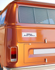 Orange van with a 'DRILL BABY DRILL!' sticker on the back