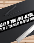 Black bumper sticker with white text on a black surface with a pen and ruler.