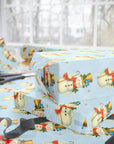 Gift box wrapped in blue wrapping paper with snowman and bluebirds.