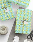 Spring wrapping paper with baby chicks nestled inside yellow flowers and butterflies on aqua background