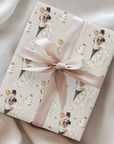 Wrapping paper featuring a retro bride and groom in classic wedding pose with groom lifting bride and wedding cake illustrations.