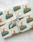 Gift wrapped in wrapping paper featuring a train and rabbit design.