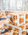 Vintage jack-o’-lantern Halloween wrapping paper featuring watercolor pumpkins with floral accent