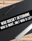 Black bumper sticker with white text on a black surface with a pen and ruler.