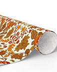 Ornate vintage-style wrapping paper with scrolling autumn leaves and floral pattern in gold, orange, and brown tones.