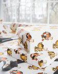 Vintage-style graduation wrapping paper featuring a lion and fox in caps holding diplomas on white background with gold star accents.