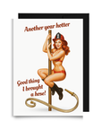 Funny firefighter birthday card with a woman in a fire helmet and bikini is sliding down a fire pole with the text, 'Another year hotter' and 'Good thing I brought a hose'.