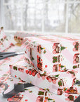 Gift box with a gingerbread Christmas train wrapping paper on table