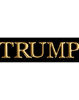 Gold 'TRUMP' text on a black background