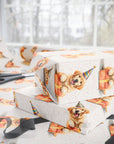 Birthday gift wrapped in paper with golden retriever dogs in party hats.
