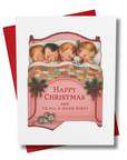 greeting card for christmas of 4 children snug in a bed under a patchwork quilt with a pup.