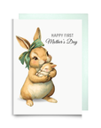 Darling card for a first time mom featuring a mother rabbit holding a baby rabbit and 'Happy First Mother's Day' text on a light green background.