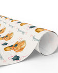 Roll of wrapping paper with baby illustrations on a white background