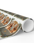 Nativity-inspired Highland cow Christmas wrapping paper featuring two cows and a baby calf in a manger setting with holiday greenery