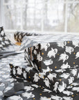 Gift wrap with ghost pattern and stars on a dark background