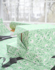 Vintage mint green floral wrapping paper with white blossoms and green vines