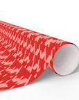 Roll of red and white patterned gift wrap on a white background