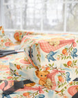 vintage style baby shower wrapping paper with peach blossoms and bluebirds stacked on table