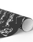 Roll of black and white wrapping paper with white polo players on horseback.