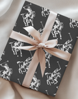 Gift wrapped in equestrian polo player pattern with pony and rider silhouettes.