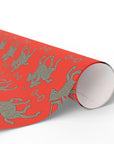 Red wrapping paper roll featuring silver polo players in a horse and rider pattern.
