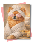 Card with a pomeranian dog in a bathrobe and towel, sitting by candles and towels.