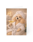 poodle in a robe holding a glass of wine with candles and towels on a greeting card.