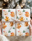 Christmas wrapping paper featuring a Pomeranian, Westie, cavalier, Golden Retreiver, and playful fox skiing down snowy slopes in Santa hats.