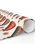Roll of wrapping paper with queen of hearts design on a off white background.