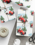 Gift wrap with Santa driving a red race car design, tied with twine, on a gray surface with scissors and string.
