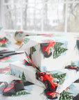 Gift boxes wrapped in festive paper with racing car design on a table.