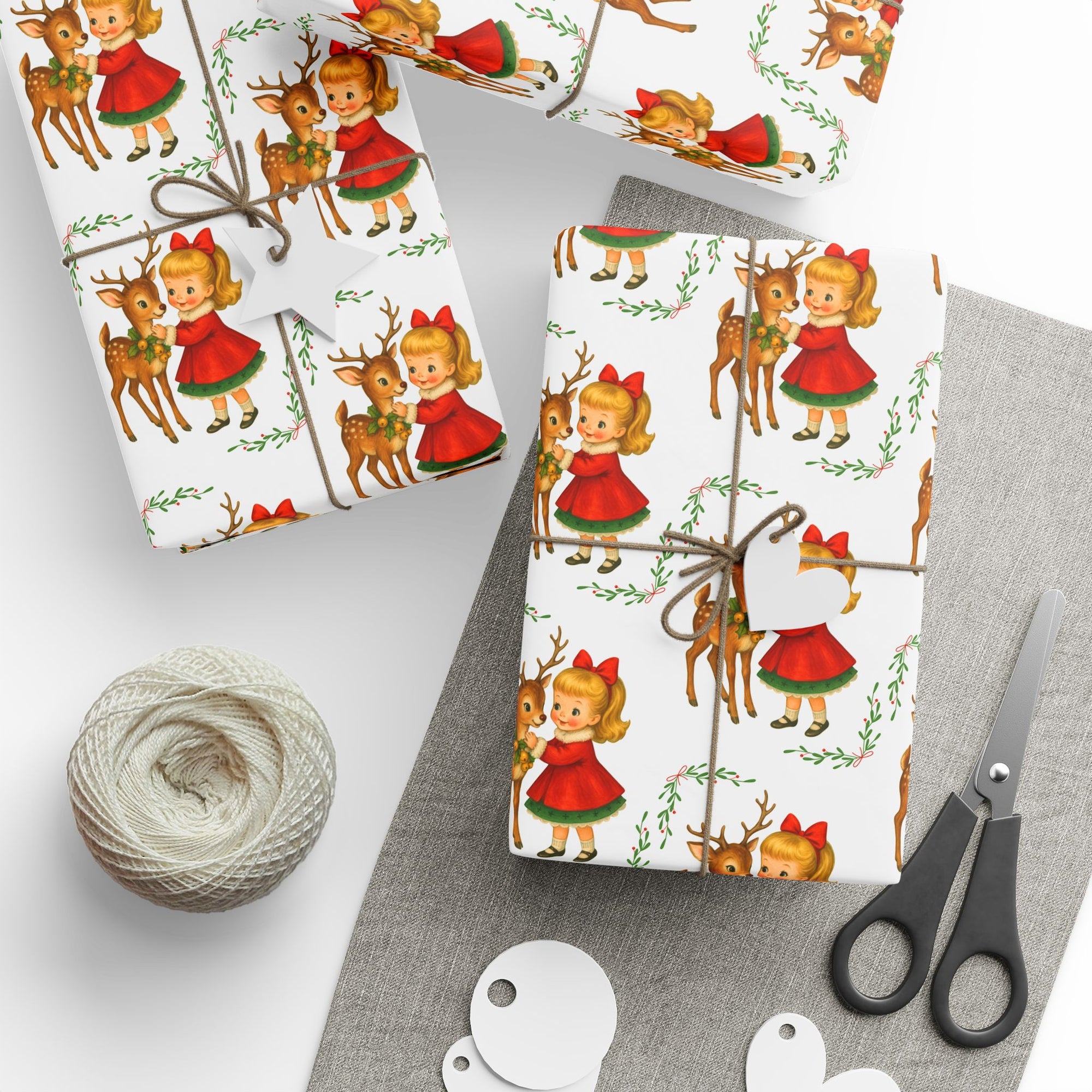 Christmas-themed gift wrap with reindeer and little girl with a red bow on a white background front view