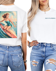 Two views of a person wearing a white t-shirt with a graphic design of a surfer girl riding a gulf of america surfboard