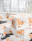 baby shower wrapping paper with rosy-cheeked baby and plush bunny