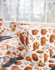Vintage Halloween wrapping paper featuring smiling jack-o’-lanterns and fall leaves