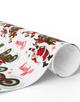 Christmas wrapping paper featuring Santa on a dirt bike doing tricks on a white background.