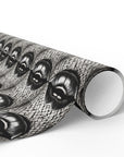 Roll of decorative paper with black and white surreal pattern of lips on a black and white background.