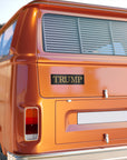 Orange van with a 'TRUMP' logo on the back