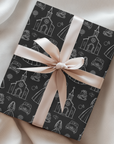 Wedding gift wrapped in black and white pattern and wrapped in a pink silk bow.