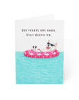 Funny dog birthday card with westie dog floating on pink flamingo pool float wearing sunglasses
