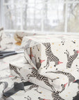 Gift wrap with zebra pattern on a table with scissors