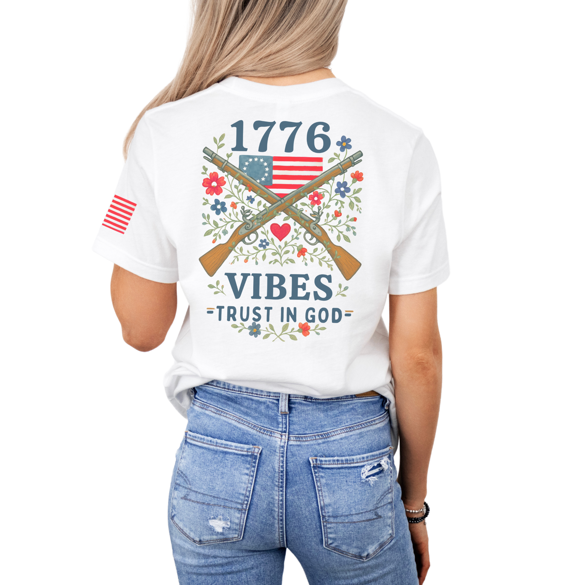 woman wearing a white t-shirt with patriotic design crossed muskets floral adorned with a betsy ross flag trust in god text back design