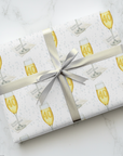 Gift wrapped in paper with champagne glass design.