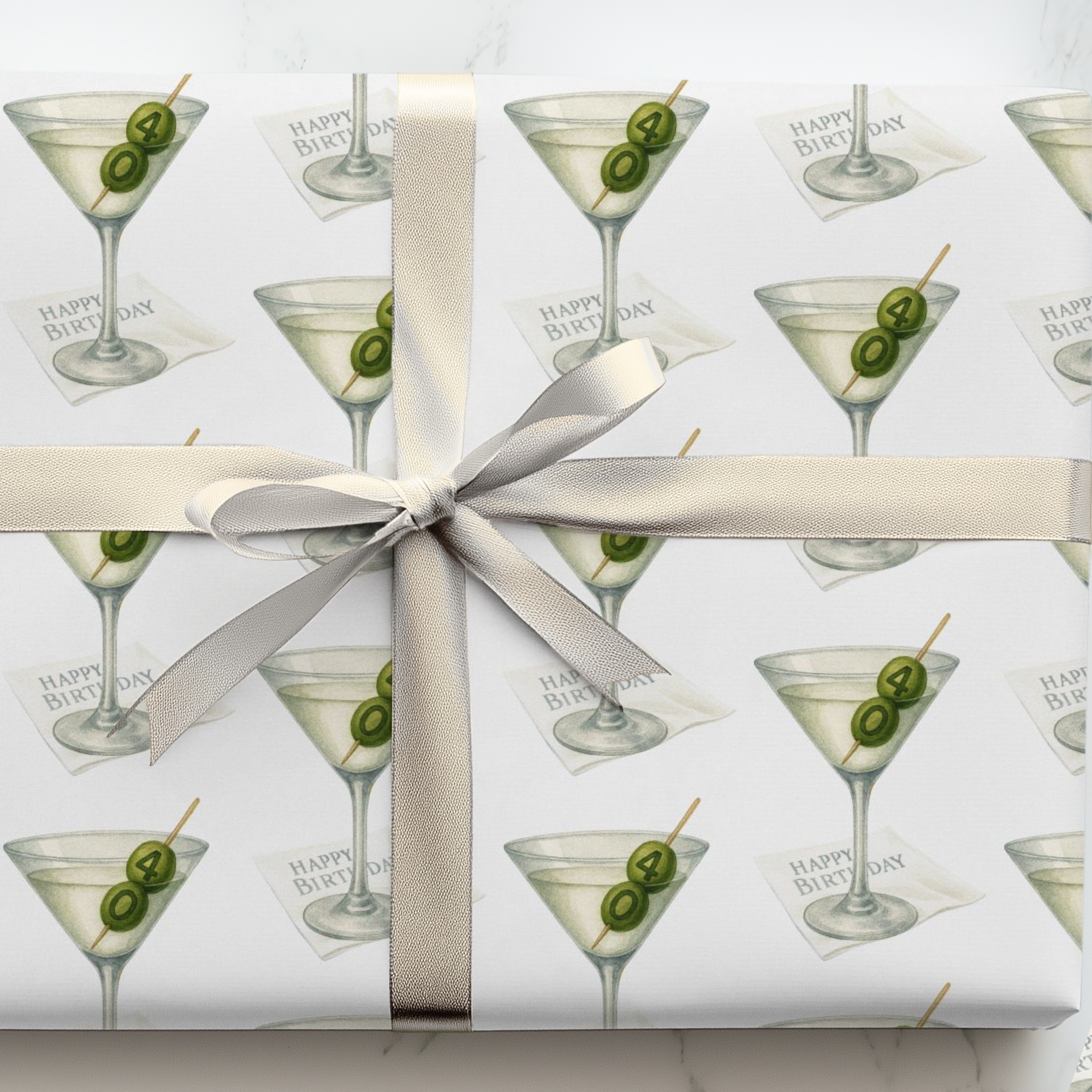 Gift wrapped in paper with martini glass design, two olives inscribed with a 4 and 0.