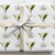 Gift wrapped in paper with martini glass design, two olives inscribed with a 4 and 0.